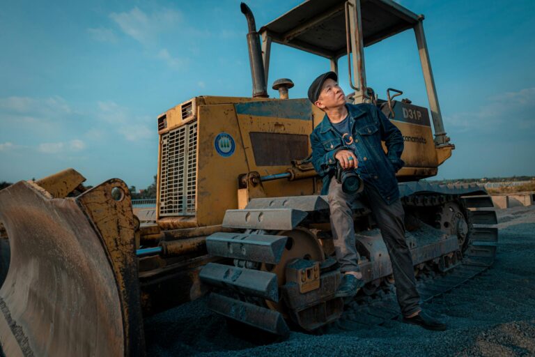 free-photo-of-man-posing-with-bulldozer-in-bien-hoa-landscape